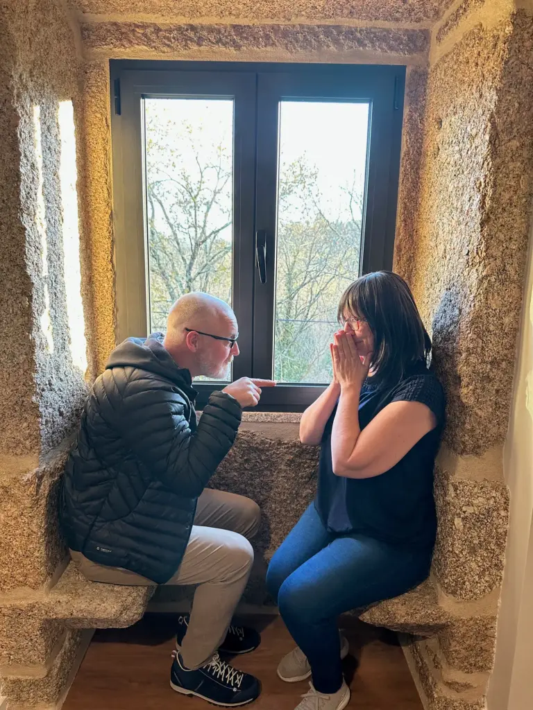 Two operators in a quiet, emotional one-on-one conversation by a window